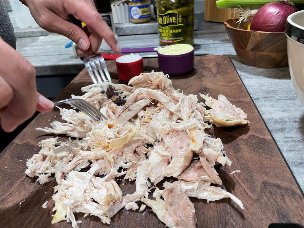 Shredding Chicken on cutting board.