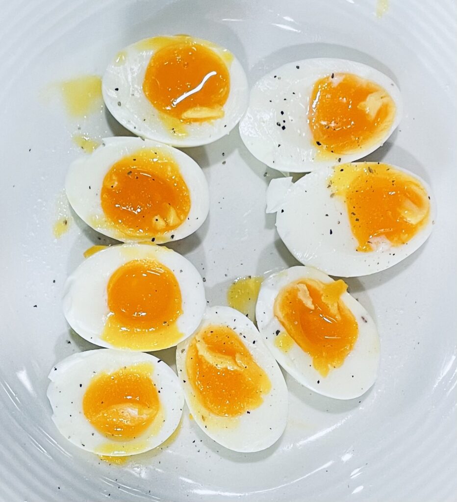 4 perfectly soft boied eggs cut diagoanlly in half.