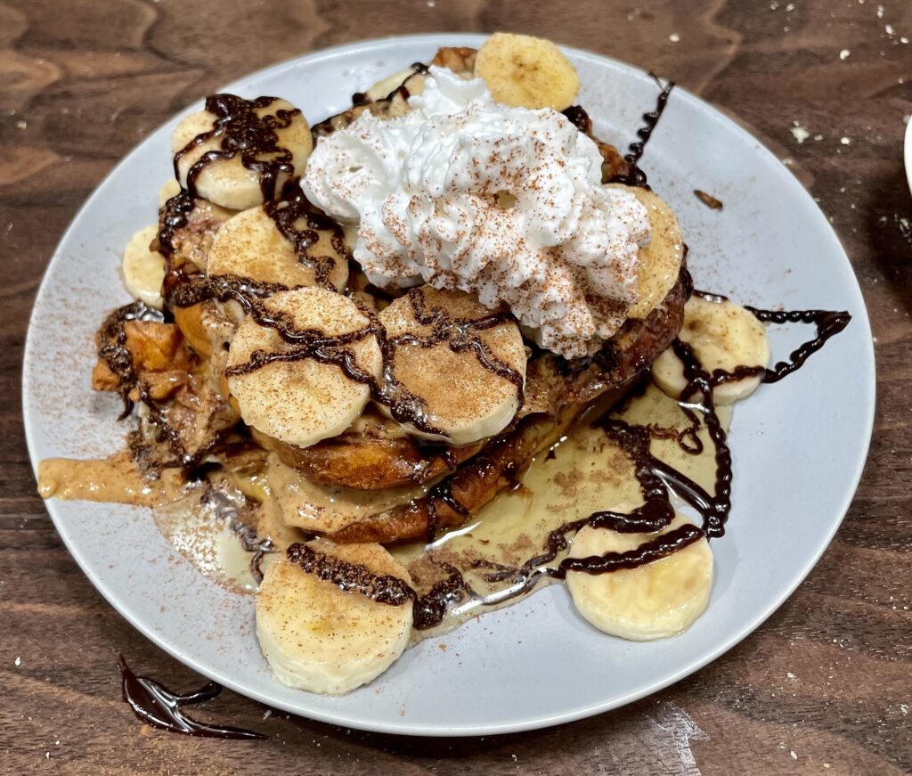 Peanut butter, banana, chocolate, whipped cream on french toast.