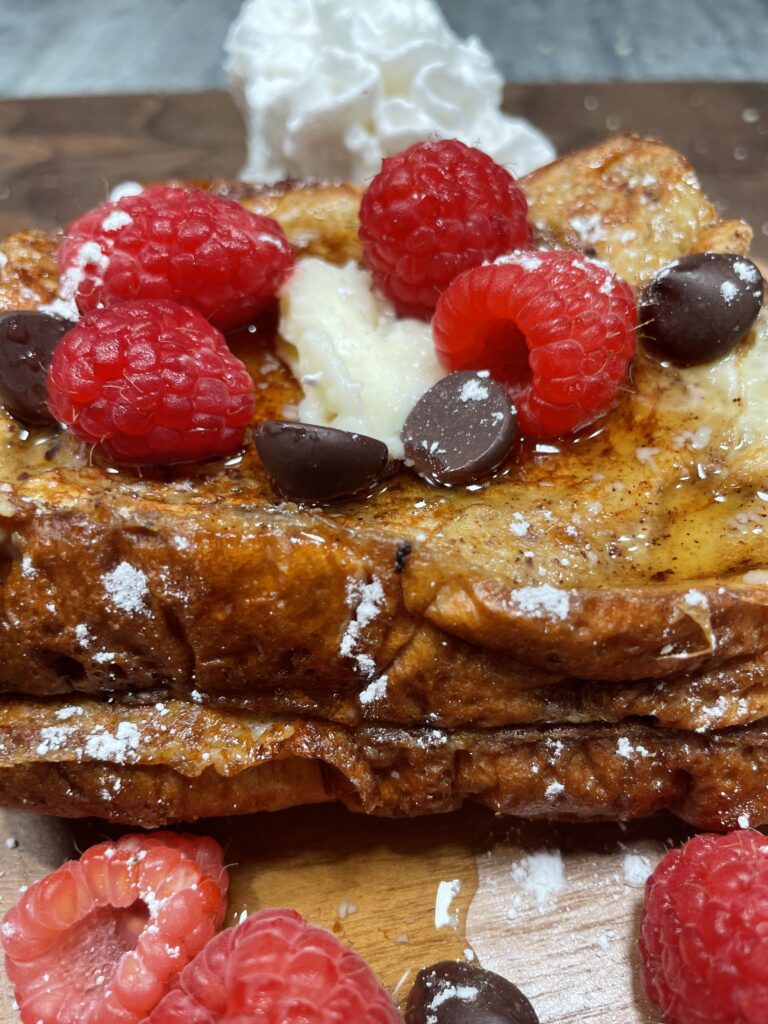 Baileys French toast with rasberries, whipped cream, and chocolate chip