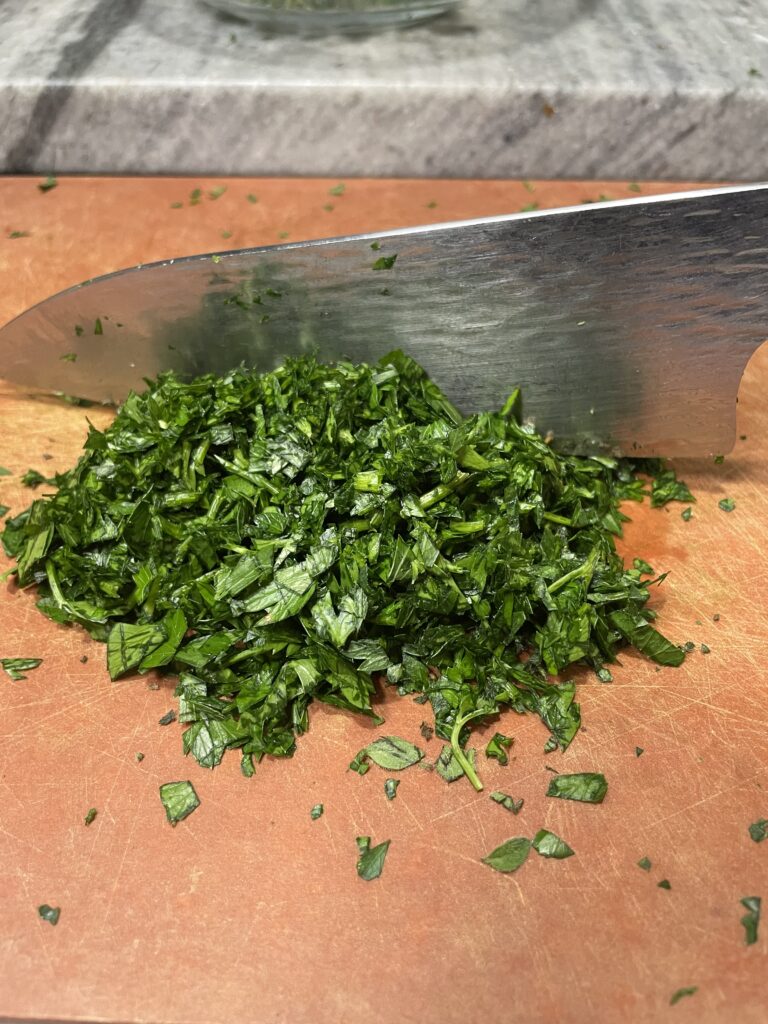 Chopped Parsley on a cutting board. Knife in the background 